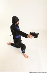 Man Young Athletic Fighting with gun Kneeling poses Casual Asian